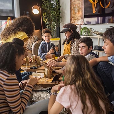 Children working together on escape room puzzles at a sleepover