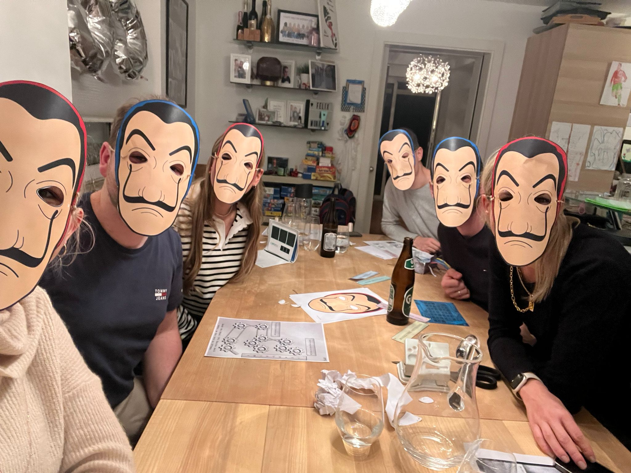 Birthday party games for adults — escape room kit on the table with friends gathered around